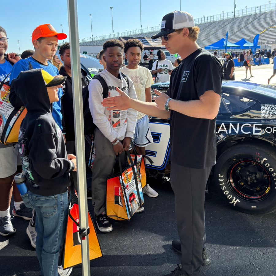 Kaeden Ballos speaking with students at a Charlotte/Concord STEAM event about racing concepts.