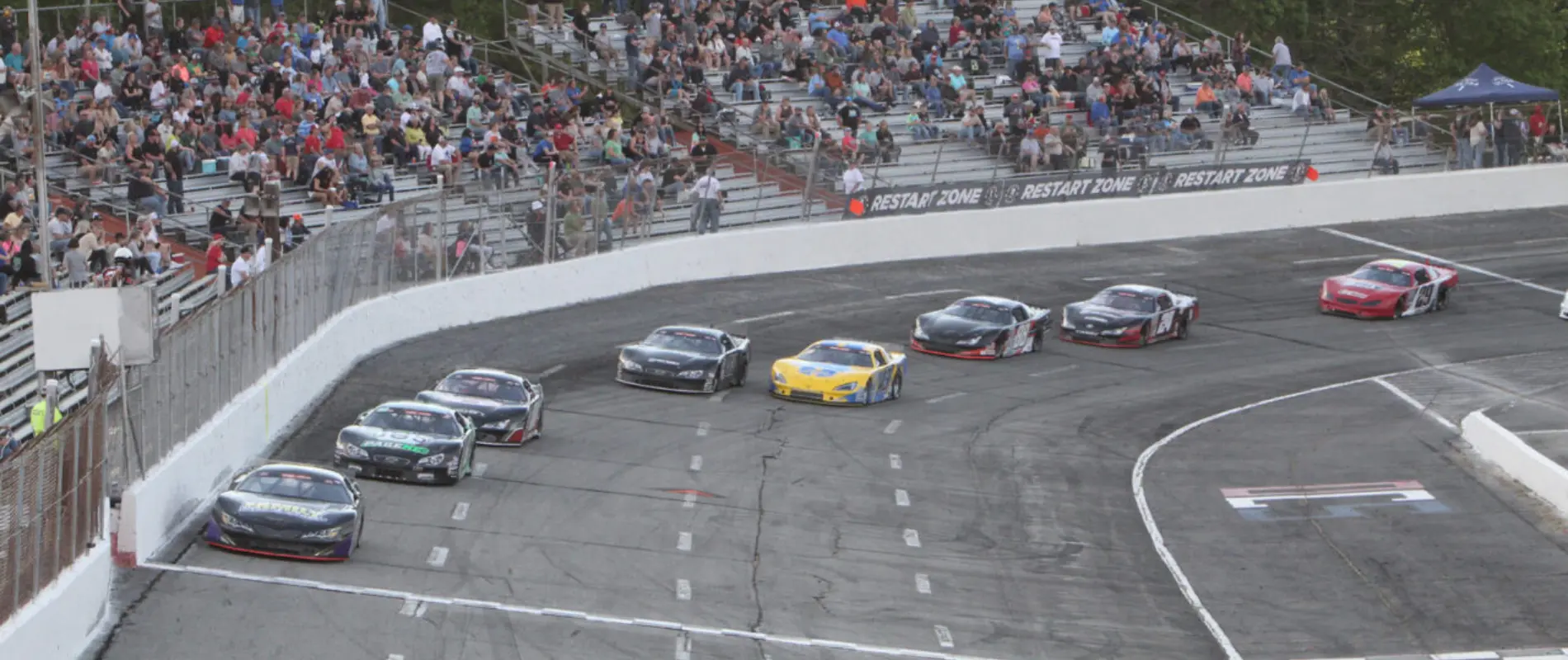 Late Models racing at Orange County Speedway on the high-banked oval.